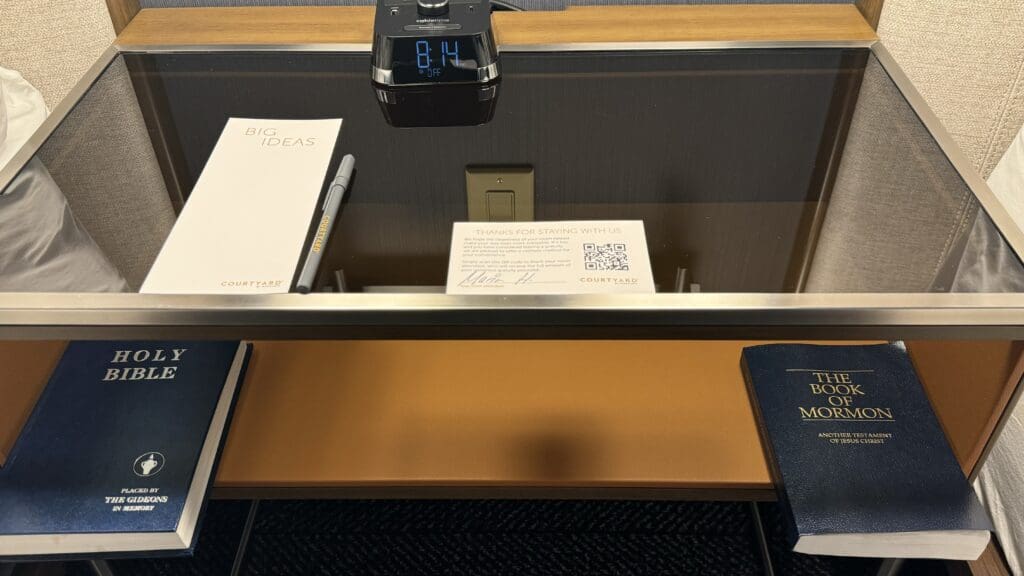 a desk with a clock and papers on it