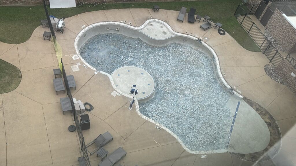 a pool with a pool and chairs