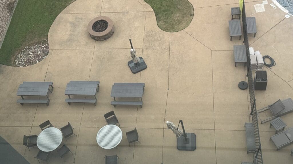 a patio with picnic tables and chairs