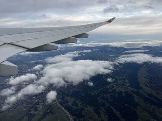 an airplane wing above clouds