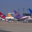 a group of airplanes parked at an airport