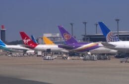 a group of airplanes parked at an airport