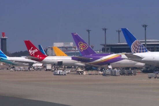 a group of airplanes parked at an airport