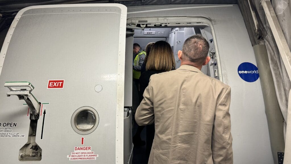 a man and woman standing in an airplane