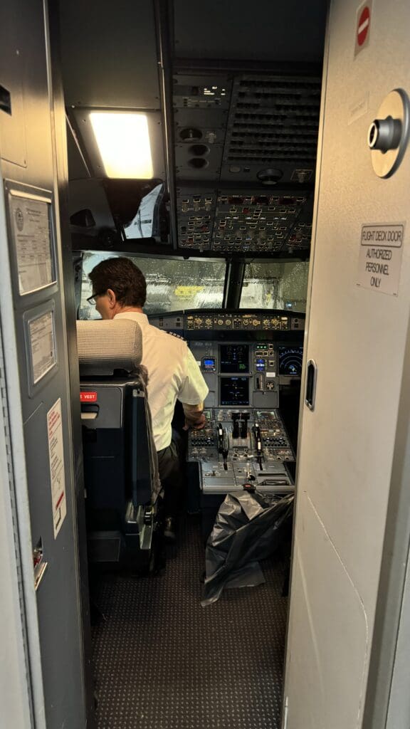 a man in a cockpit of an airplane