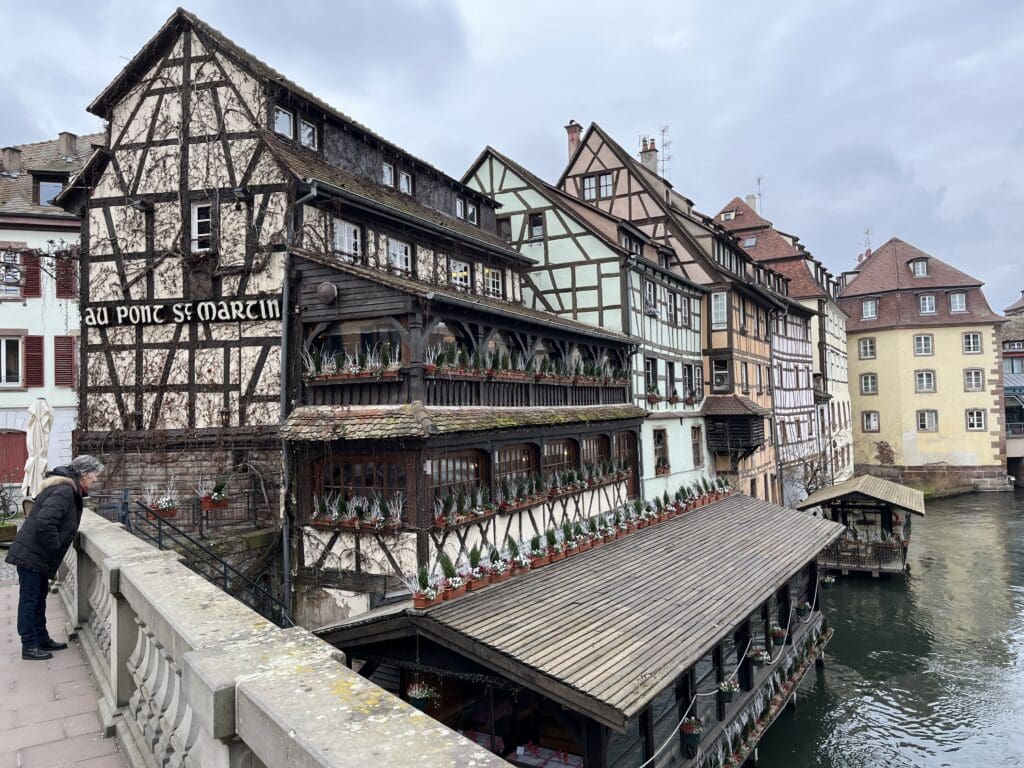 a bridge over water with buildings and a bridge