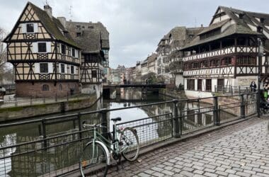 a bicycle parked on a bridge over a canal