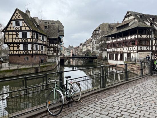 a bicycle parked on a bridge over a canal