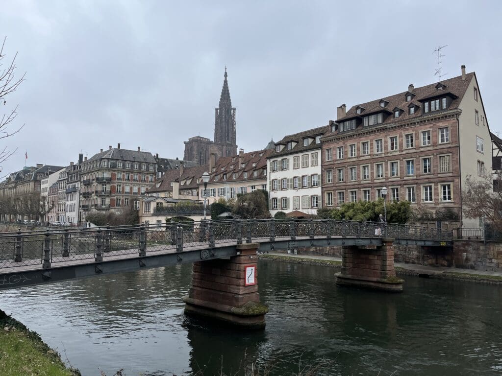 a bridge over a river with buildings in the background