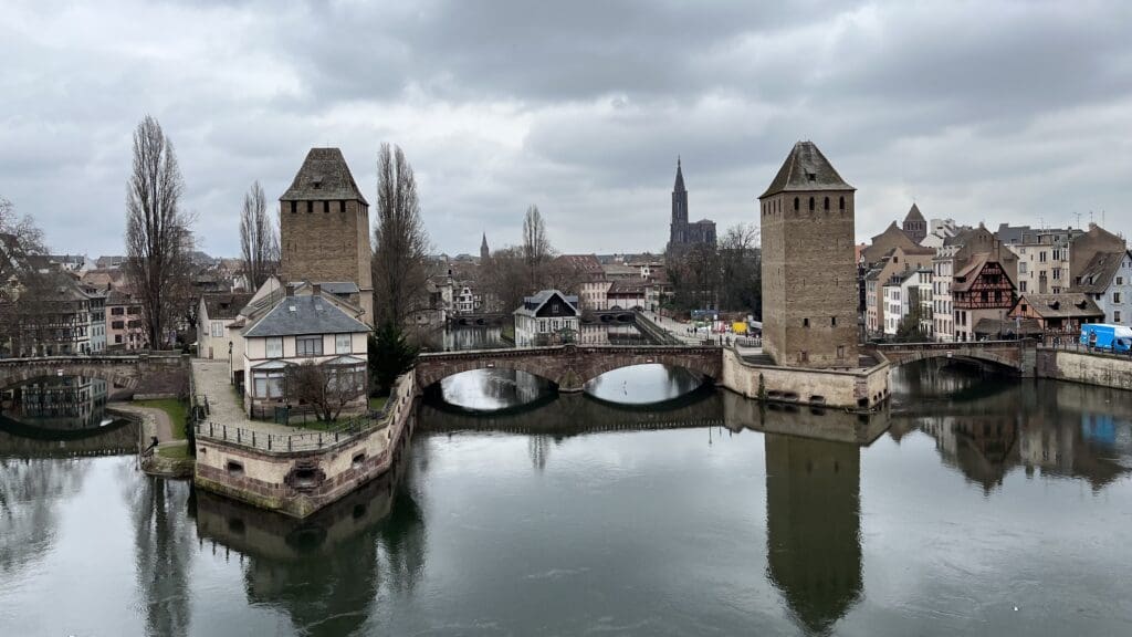 a bridge over a river with towers and buildings