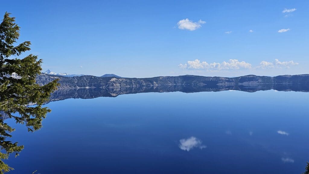 a body of water with mountains in the background