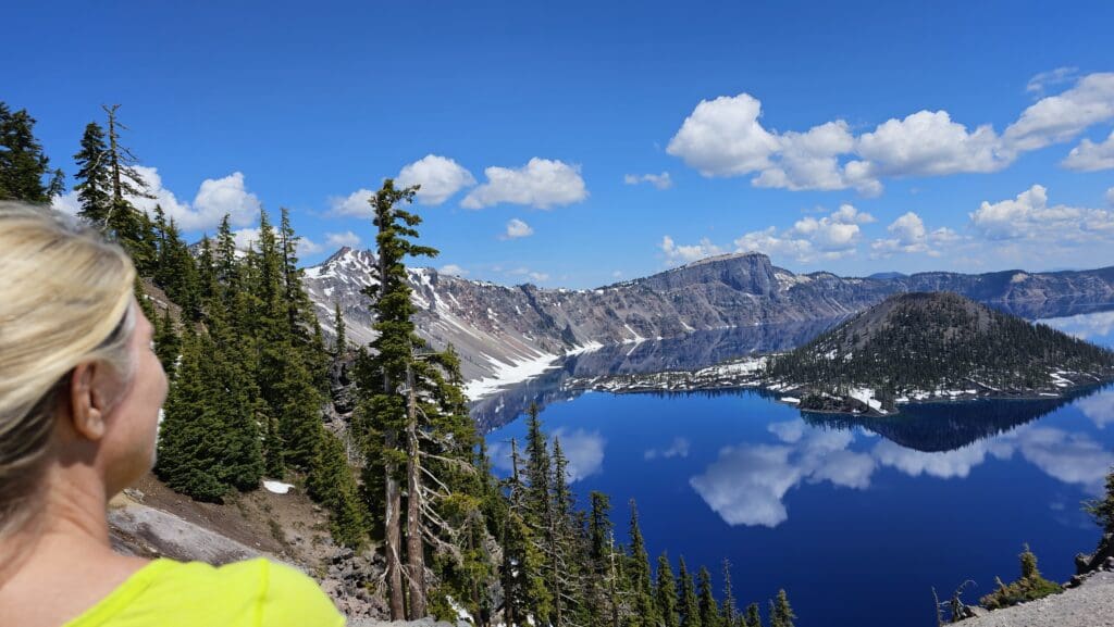 a lake surrounded by trees and mountains