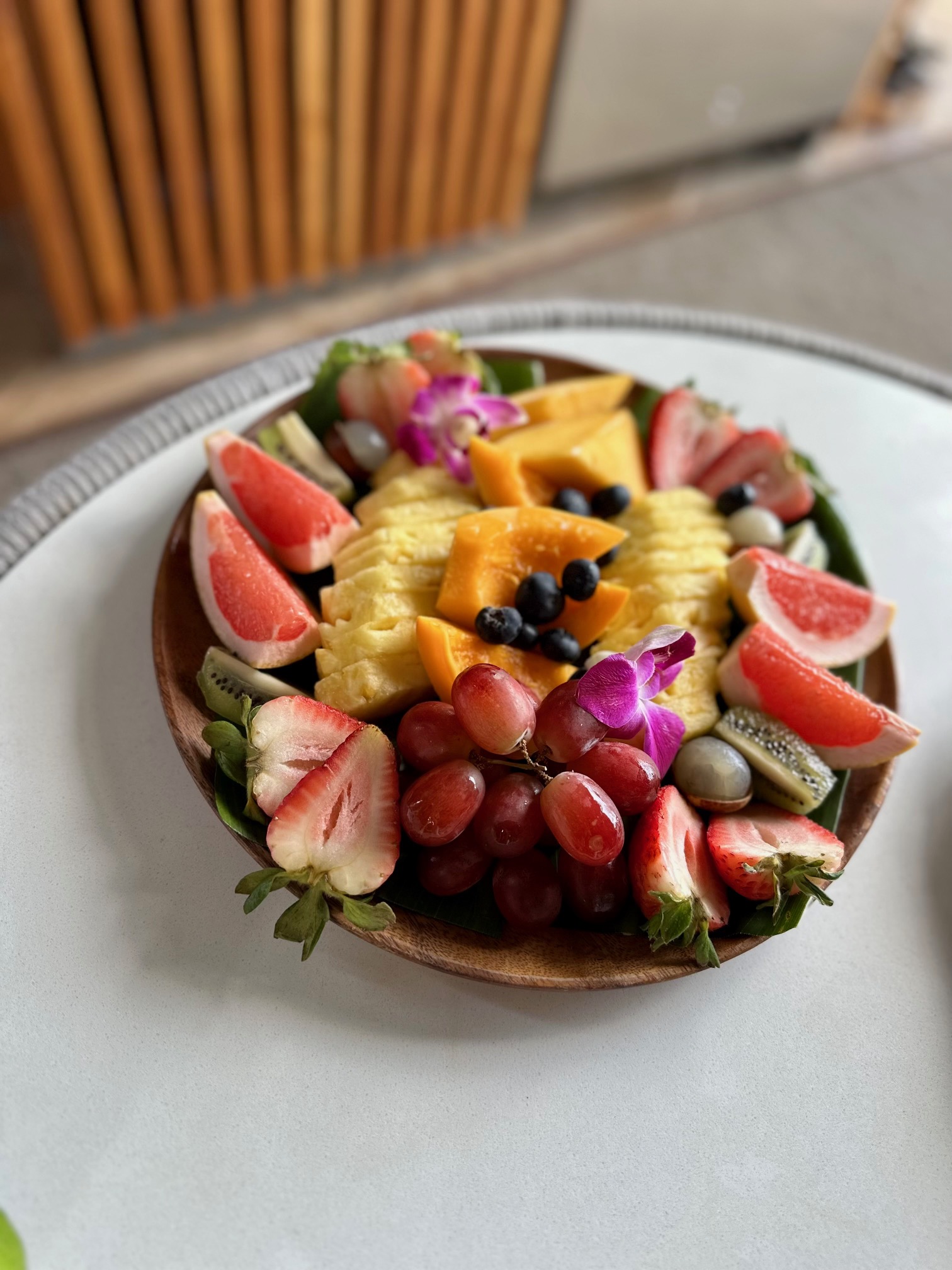 a plate of fruit on a white surface