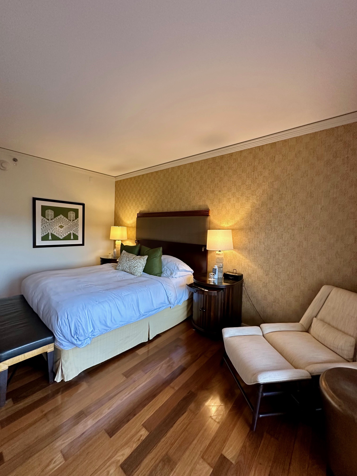 a bedroom with a bed and a chair at the Ritz Carlton Maui