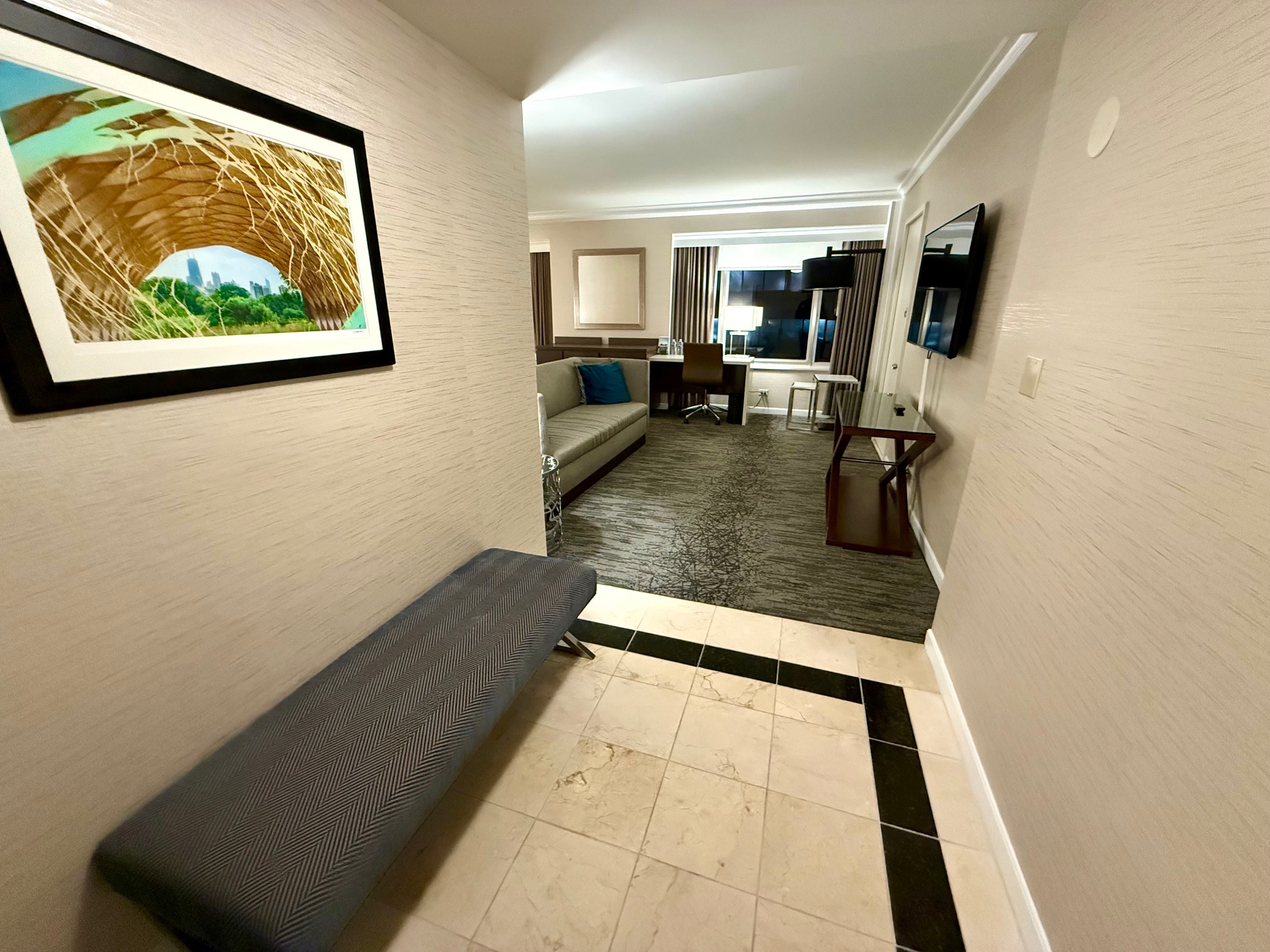 a hallway with a bench and a couch