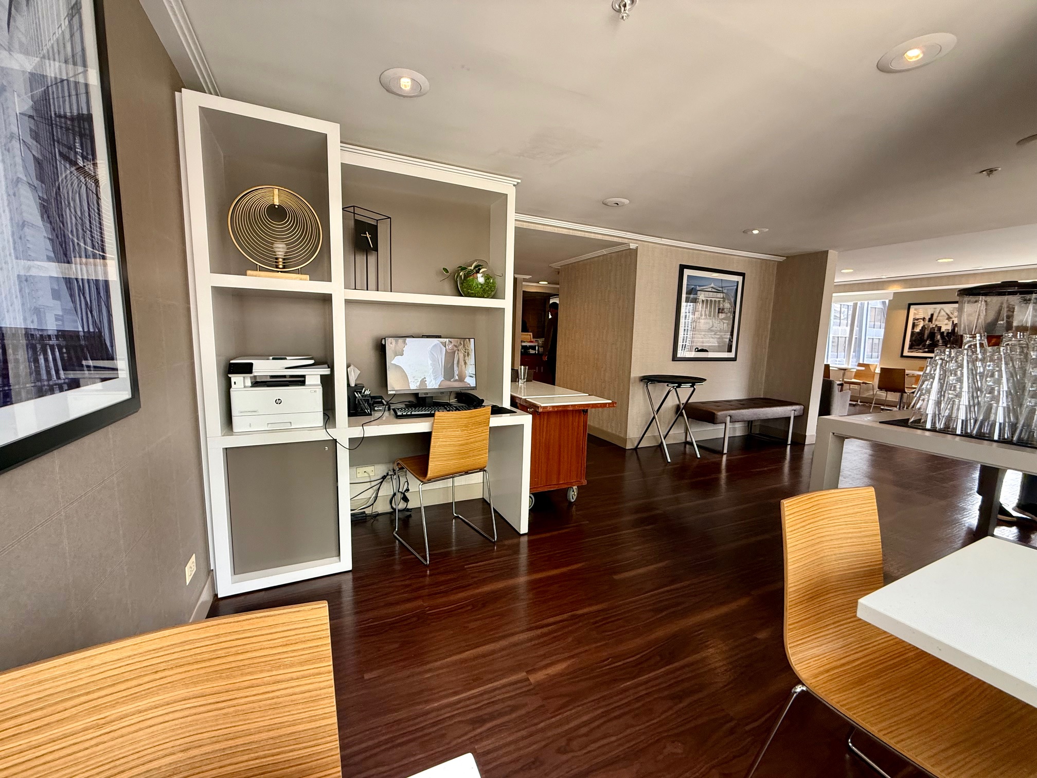 a room with a computer desk and chairs