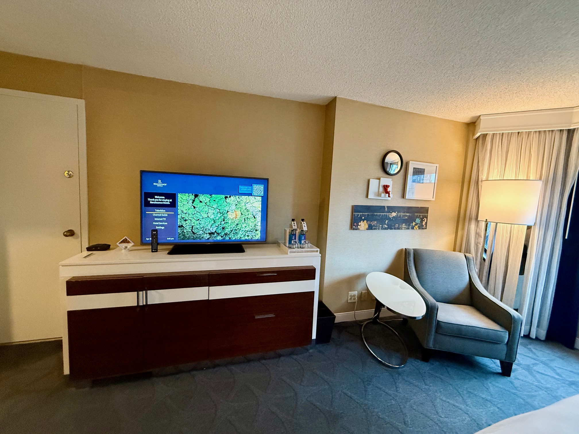 a room with a television and a chair at the Renaissance Chicago Downtown