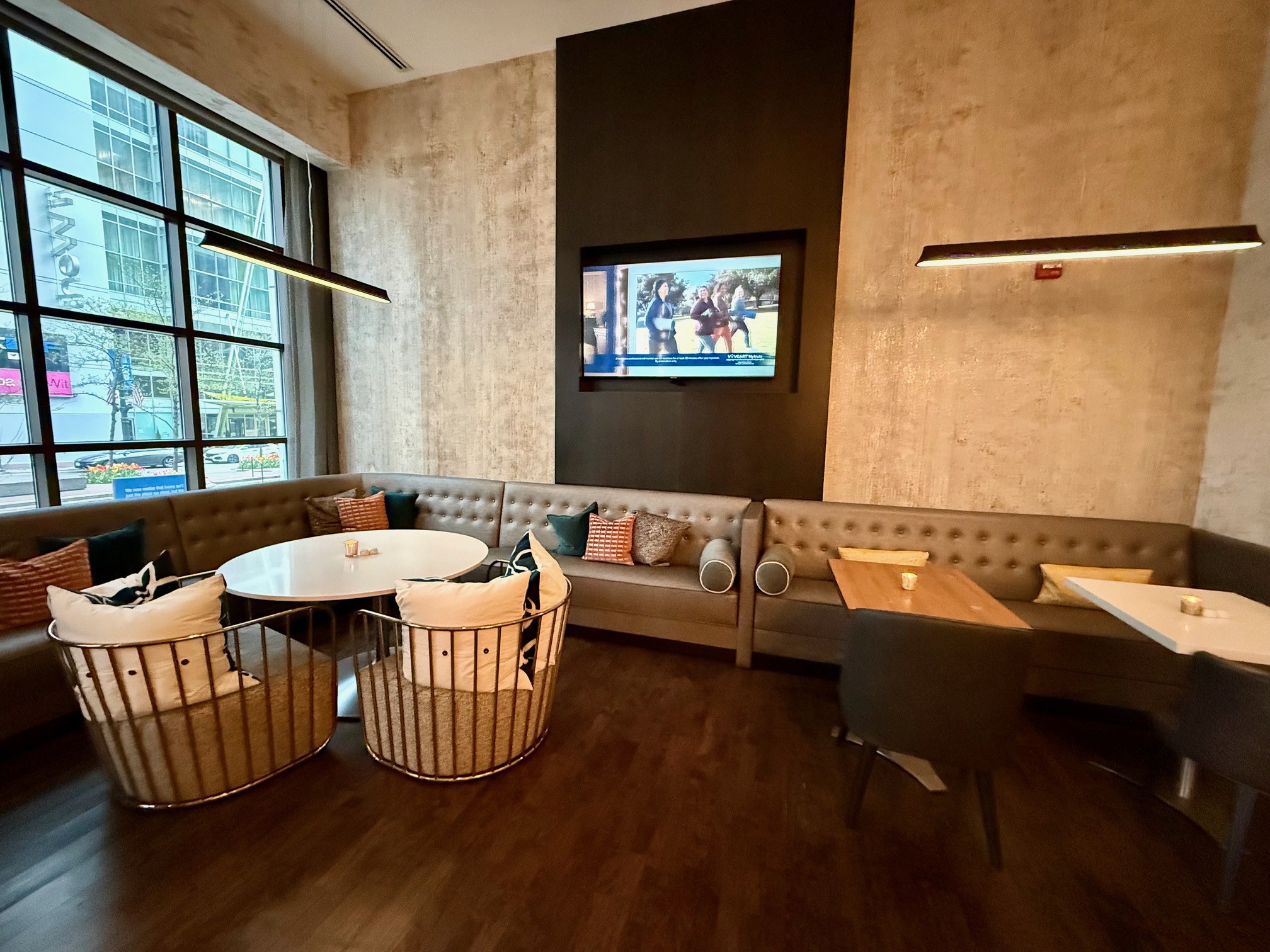 a room with a booth and a tv