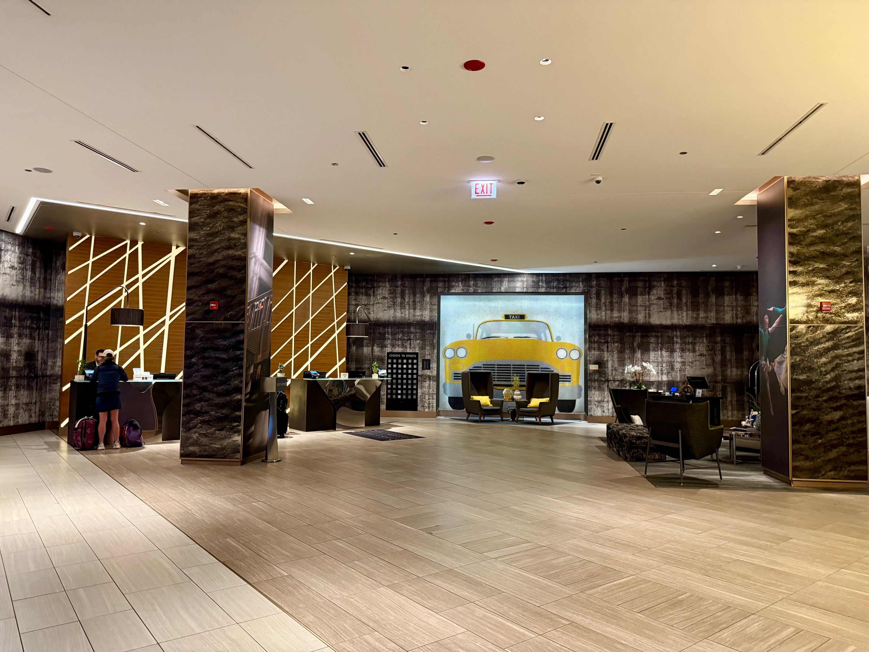 a lobby with a large wall and chairs at the Renaissance Chicago Downtown