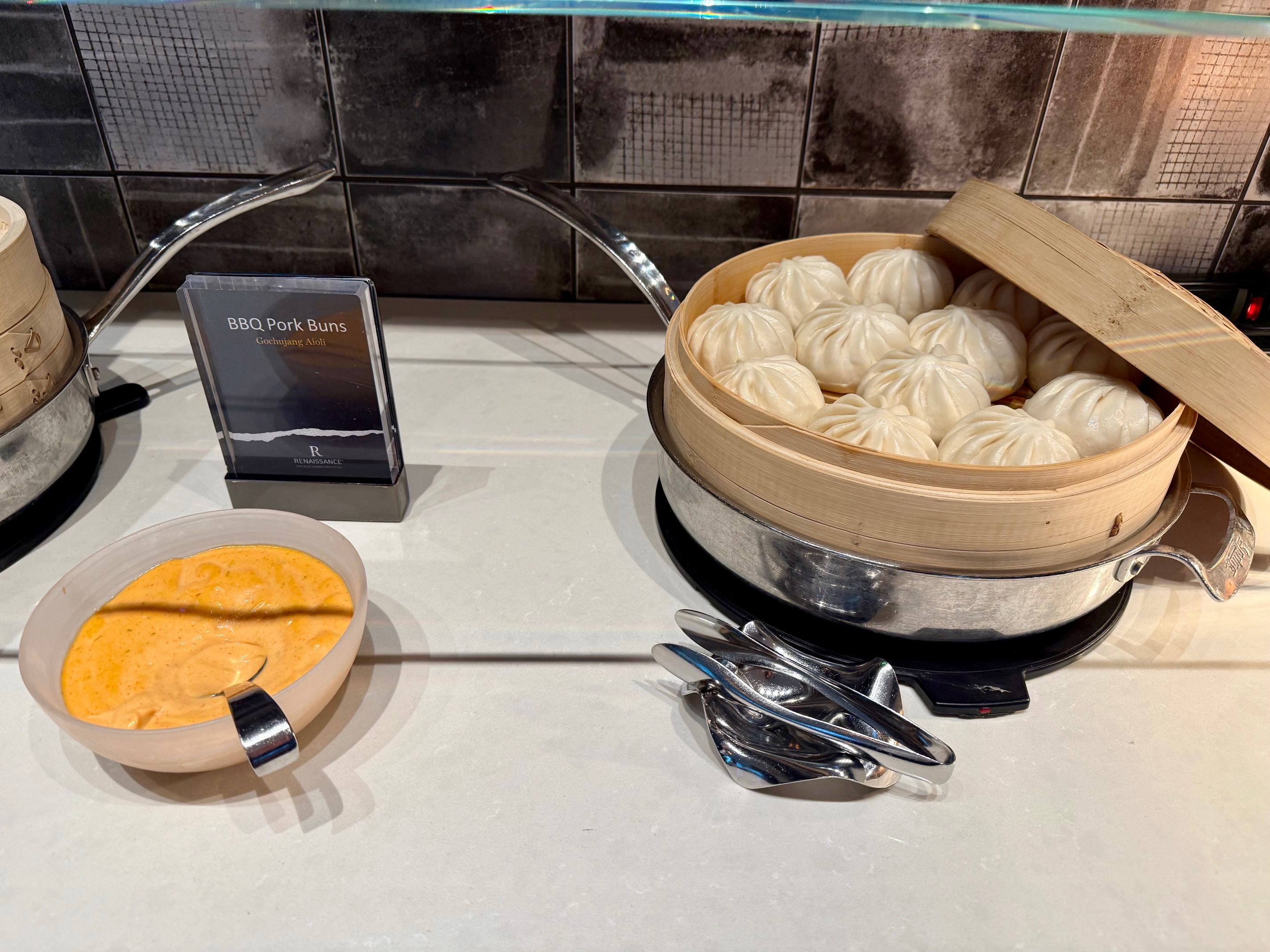 a bowl of food and spoons on a table