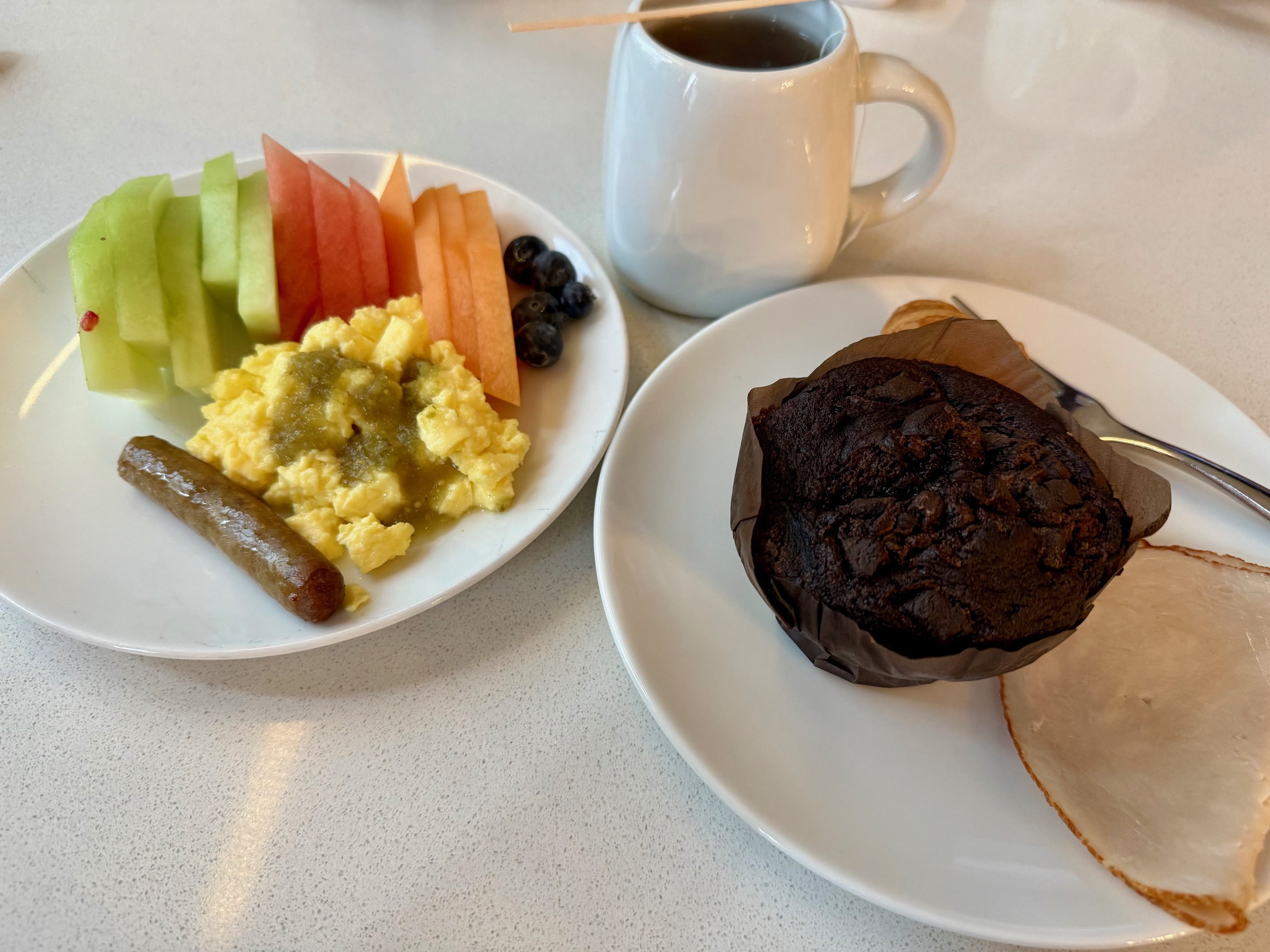 a plate of food and a cup of coffee
