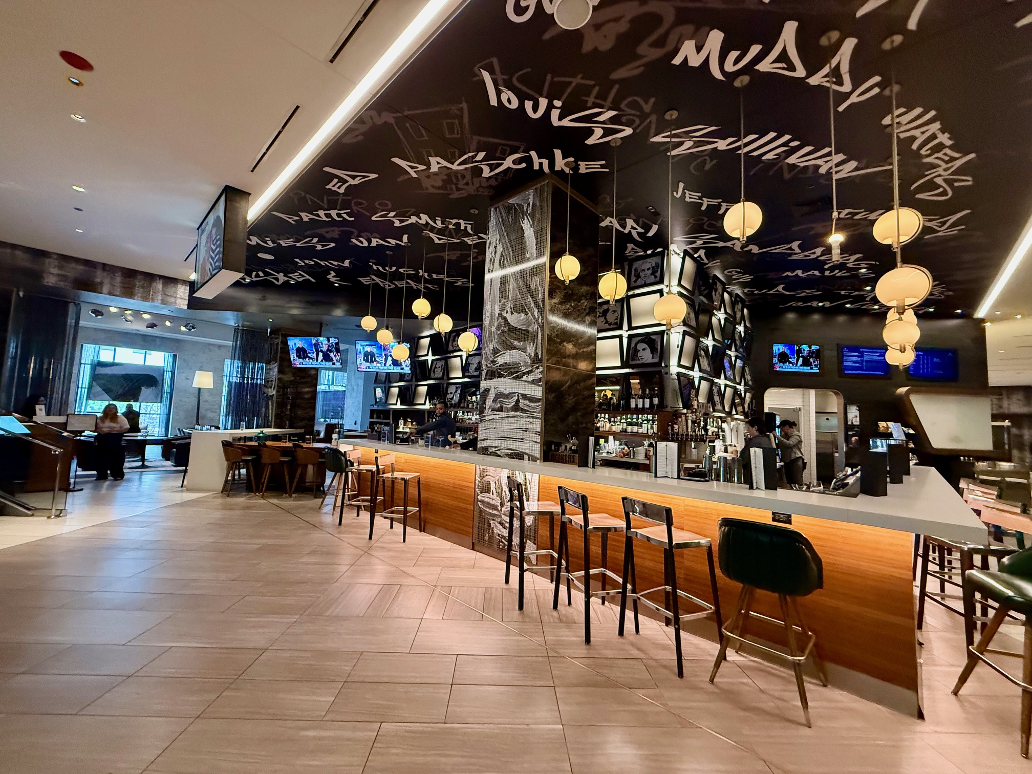 a bar with chairs and lights