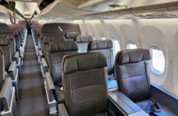 a row of seats in an American Airlines A319 First Class cabin