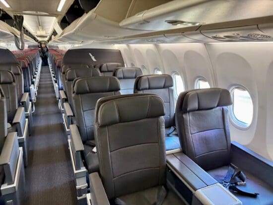 a row of seats in an American Airlines A319 First Class cabin