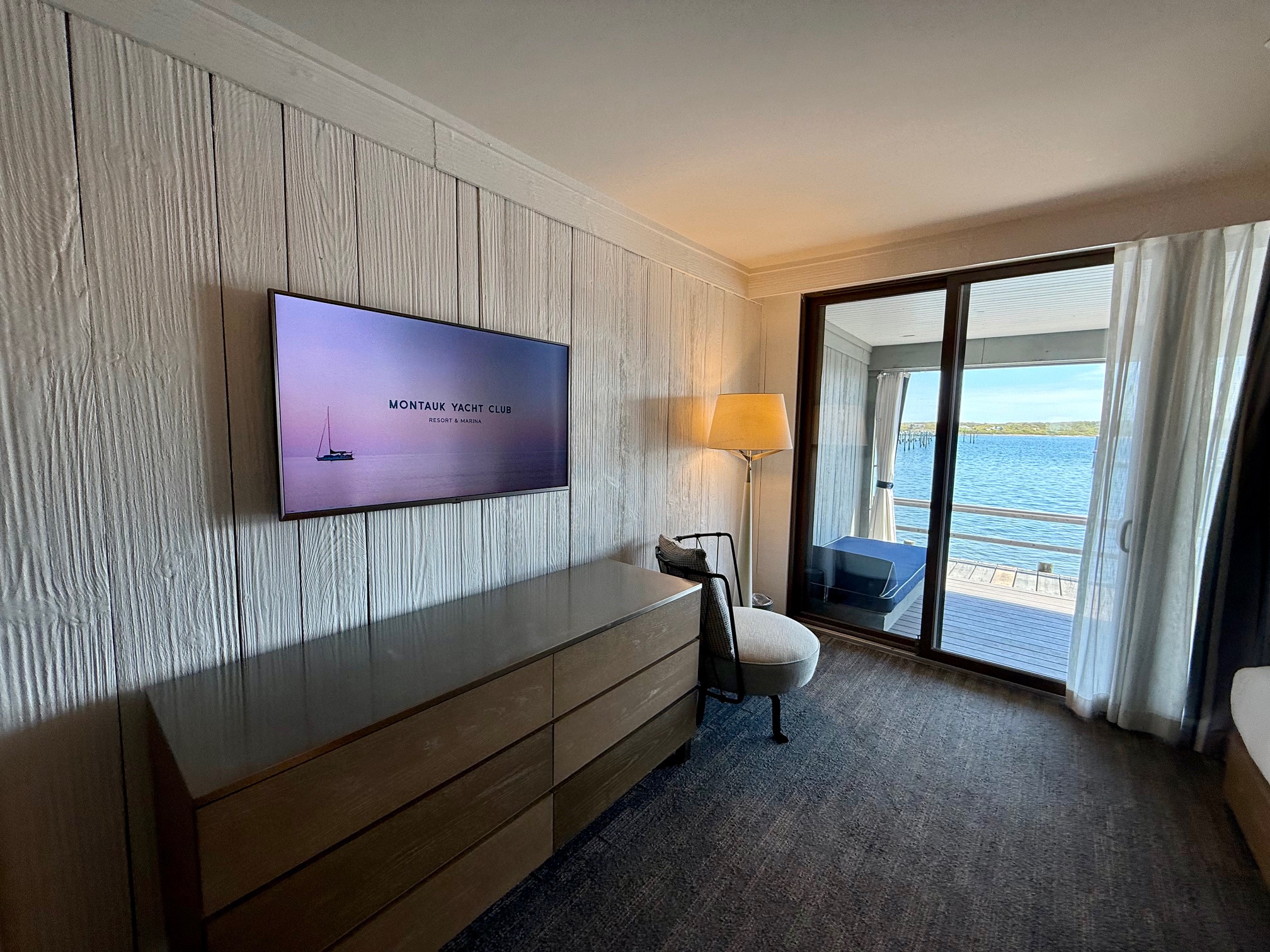 a room with a television and a glass door at the Montauk Yacht Club