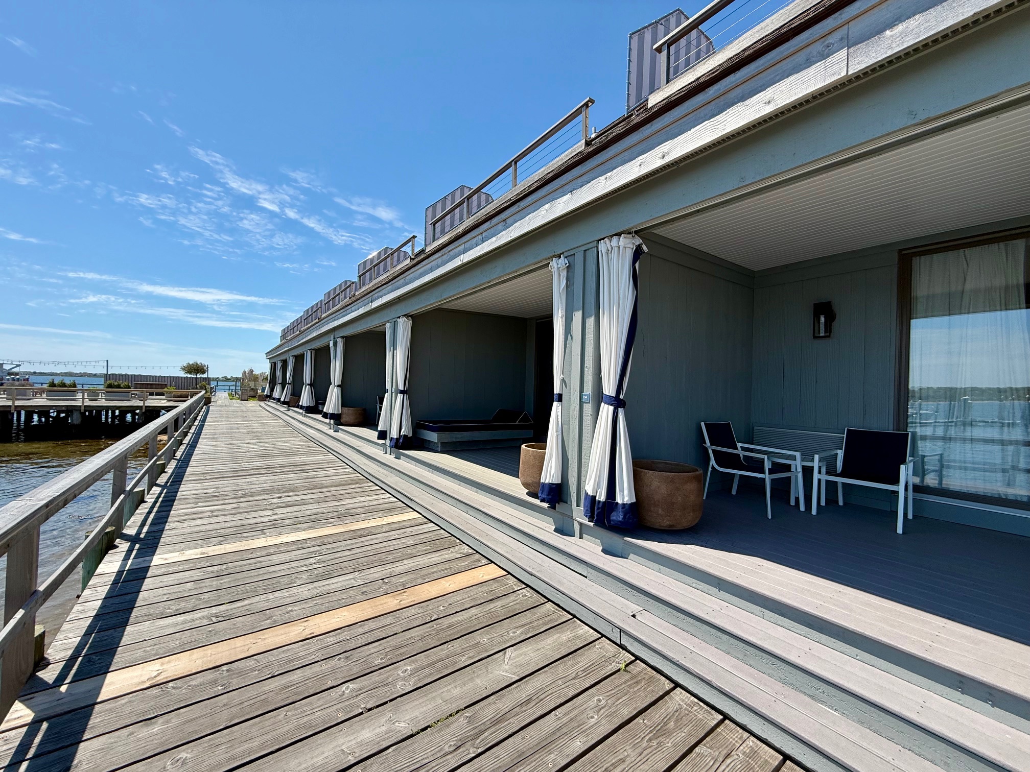a deck with chairs and umbrellas on it