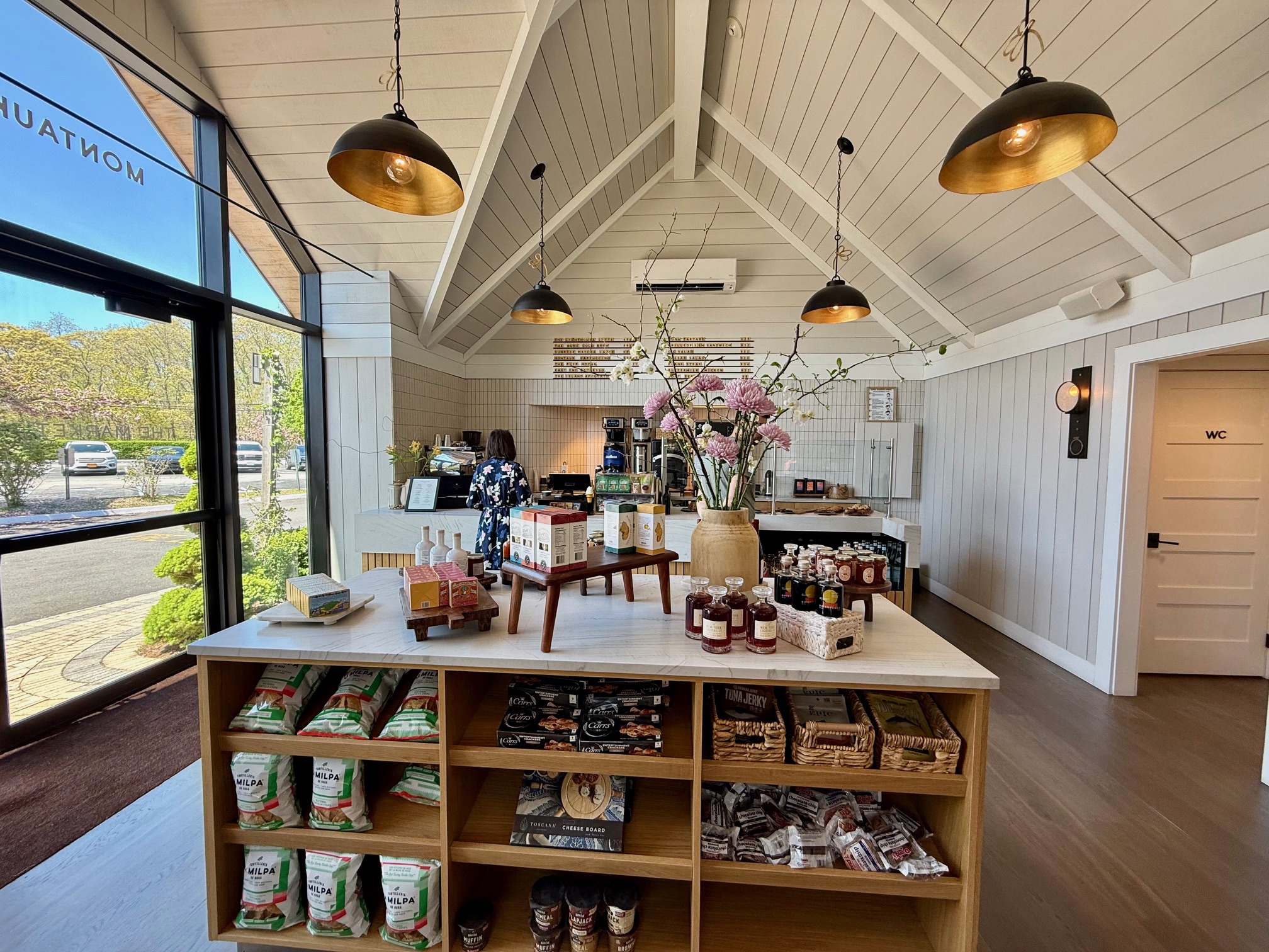 a store with shelves and a vase of flowers