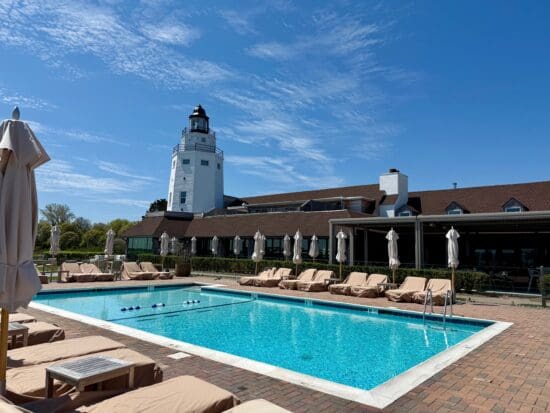 a pool with lounge chairs and umbrellas at the Montauk Yacht Club