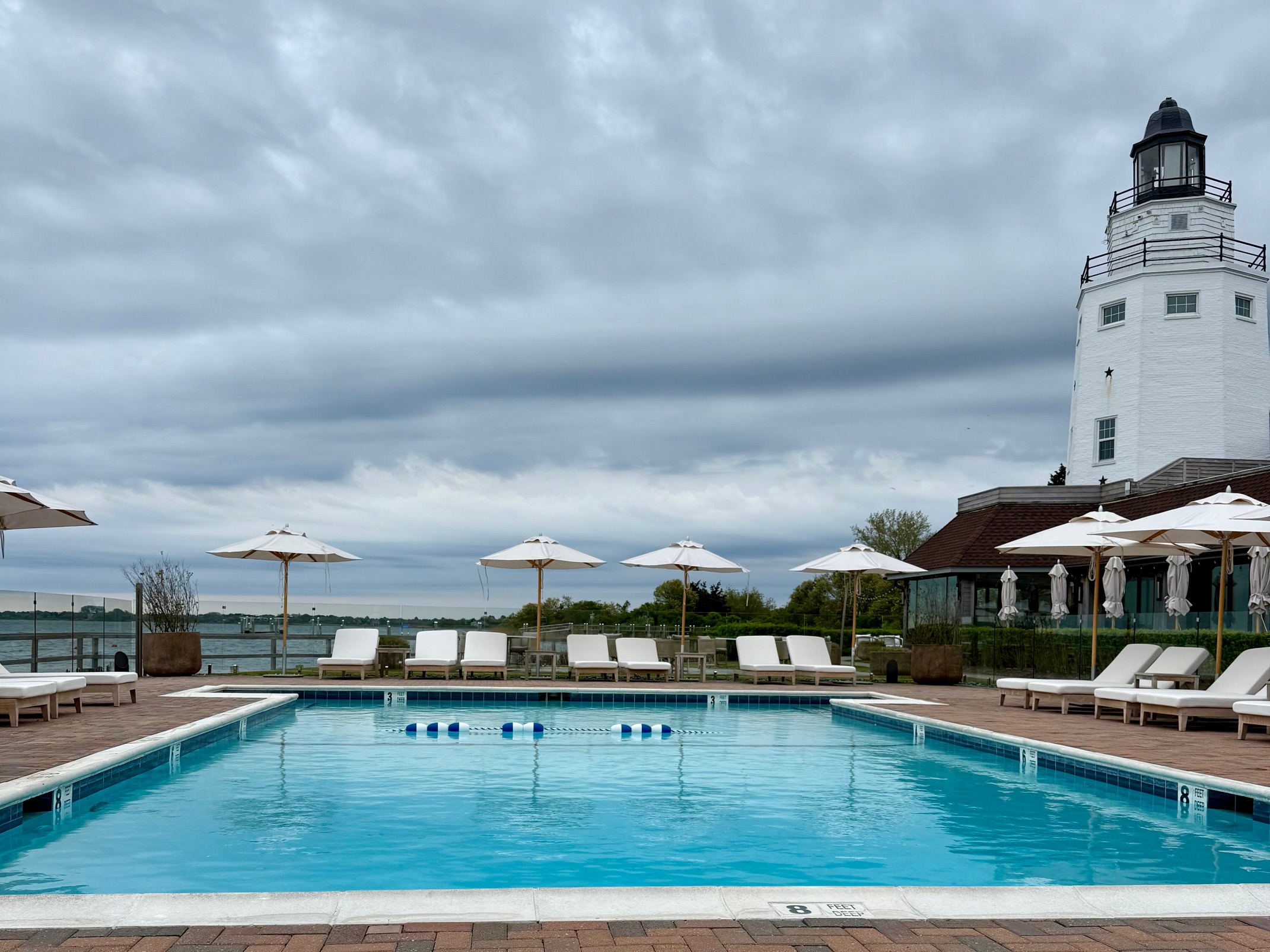 a pool with umbrellas and chairs