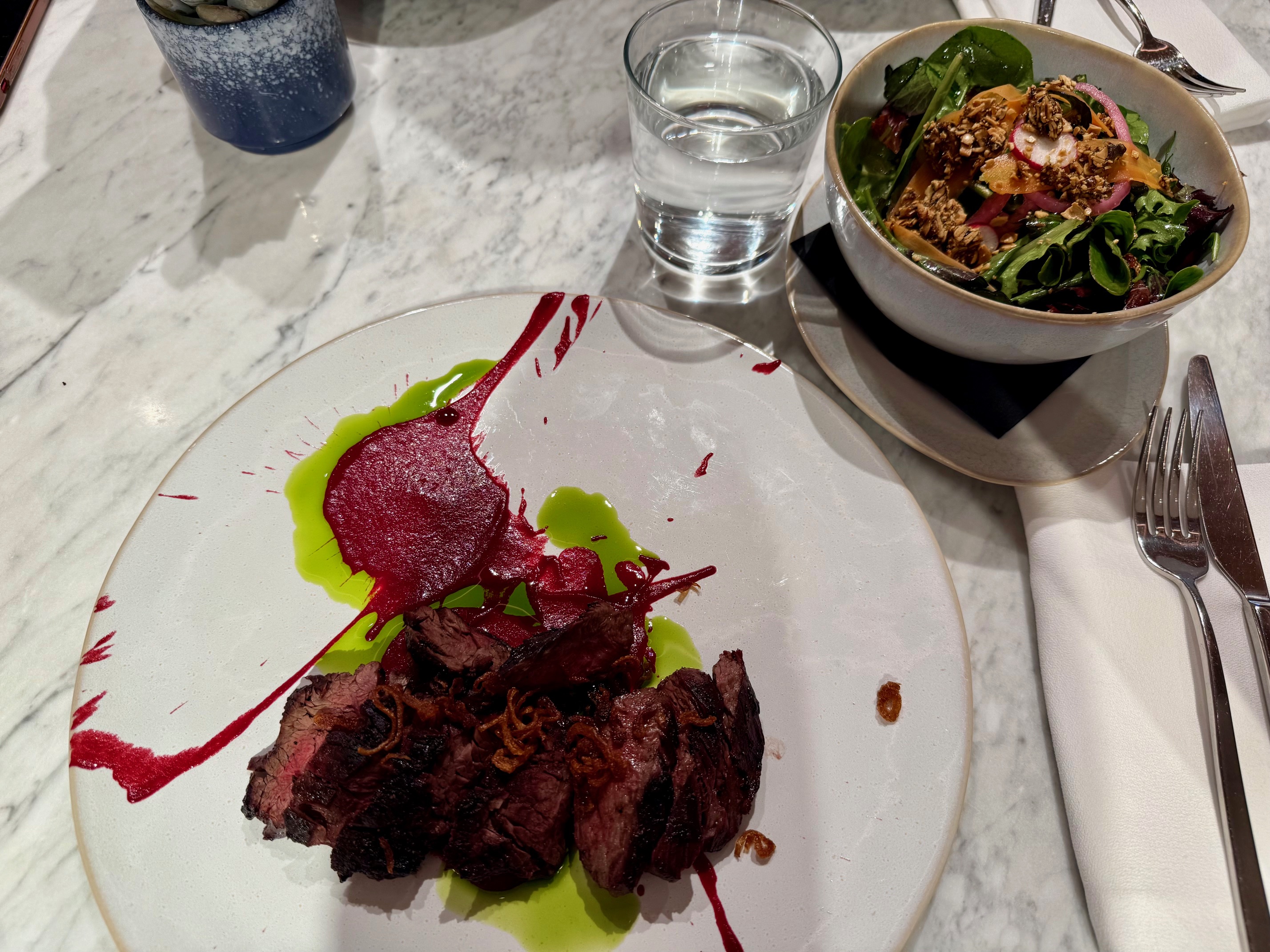 a plate of meat and salad