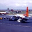 a group of people standing next to a plane