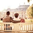 a man and woman sitting on a bench