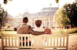 a man and woman sitting on a bench