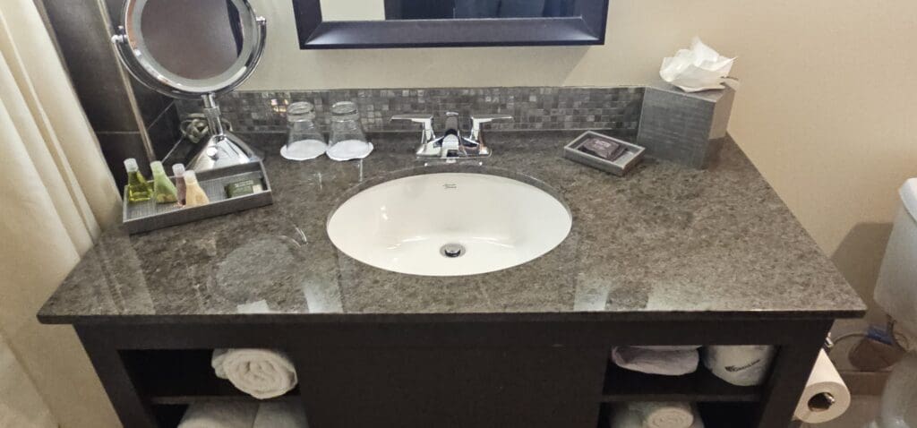a bathroom sink with a mirror and a mirror