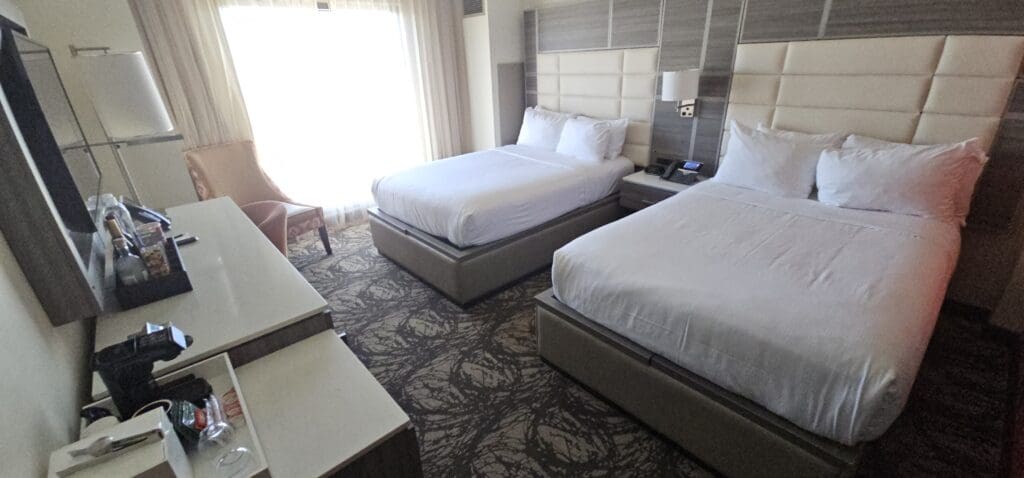 a room with two beds and a chair