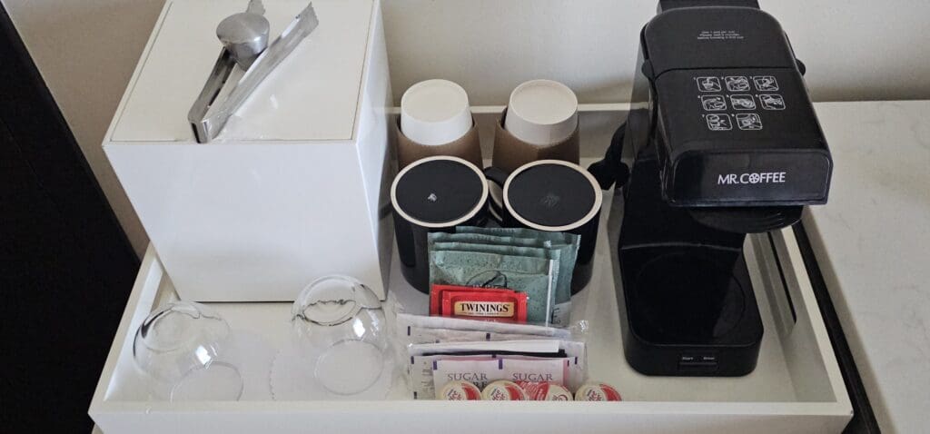 a coffee maker and coffee cups