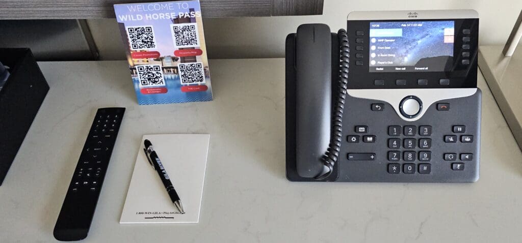 a telephone and a pen on a desk