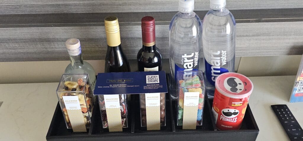 a shelf with bottles of food and drinks