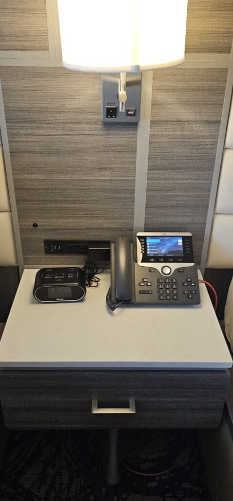 a telephone and alarm clock on a table