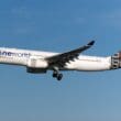 a white airplane flying in the sky