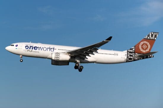 a white airplane flying in the sky