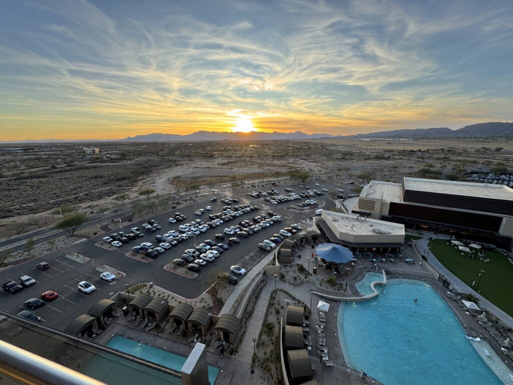 a parking lot with cars and a pool in the middle