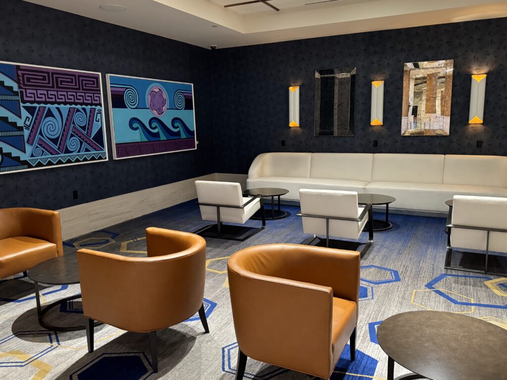a room with chairs and art on the wall