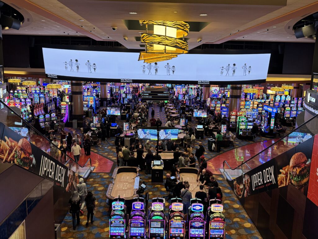 a large room with lots of slot machines and people