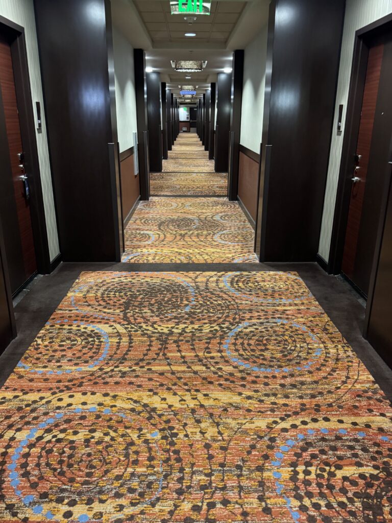 a hallway with a carpeted rug
