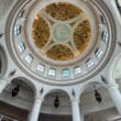 a ceiling with columns and a painted ceiling